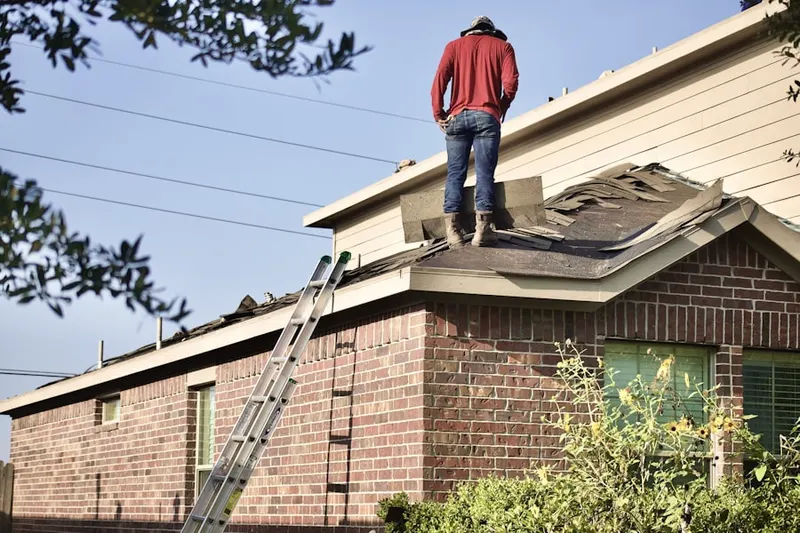Professional roofer working on a residential roof in Bergen - Lafayette